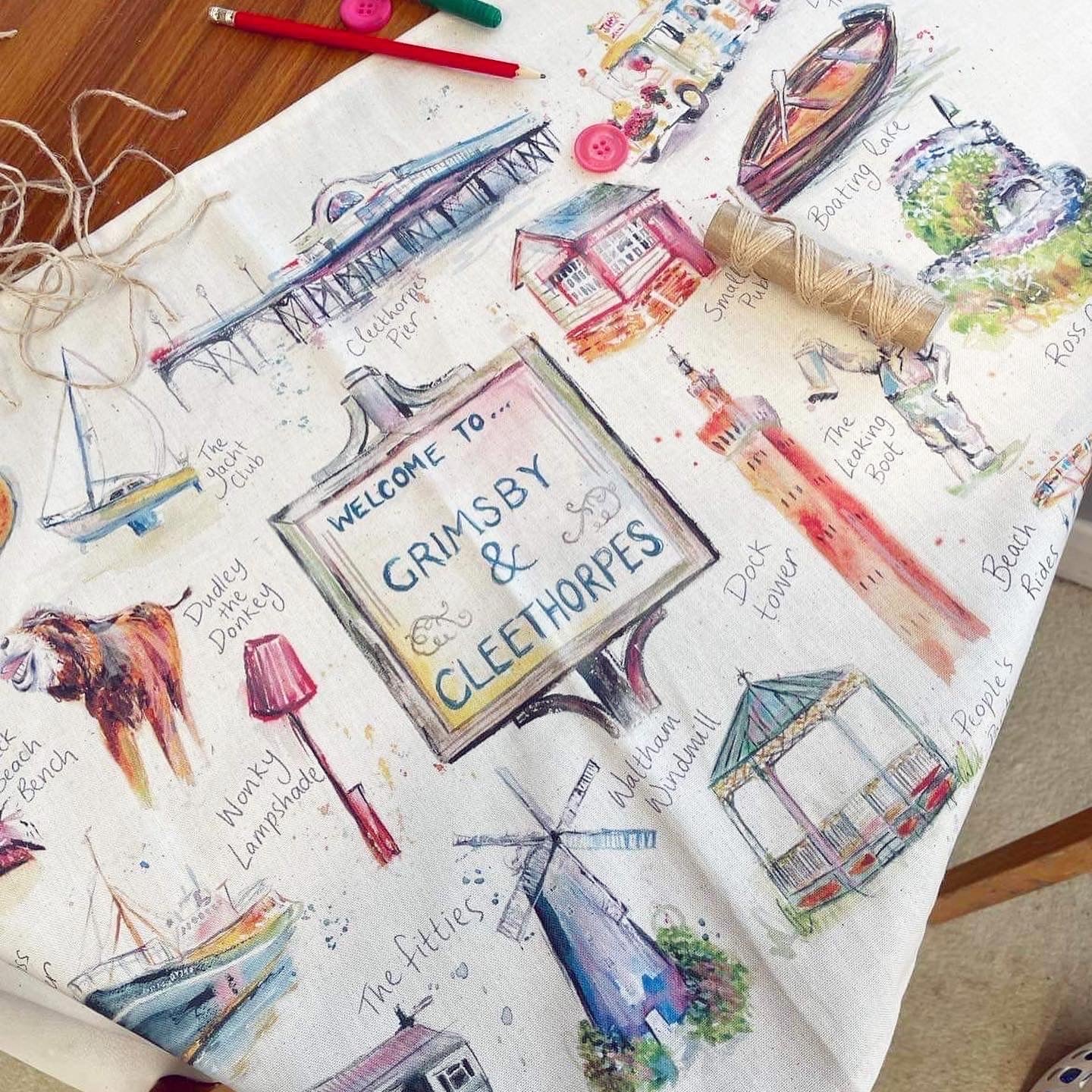Organic tea towel as part of the luxury homeware range, featuring watercolour illustrations of local landmarks in Grimsby and Cleethorpes by local artist, Eve Leoni Smith.
