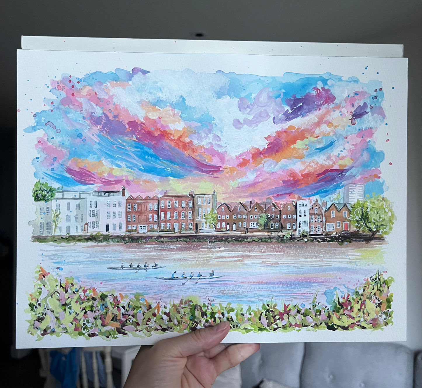 A mixed media painting of the Chiswick Riverside, featuring rowers on the River Thames at sunset. Painted by local artist, Eve Leoni Smith.