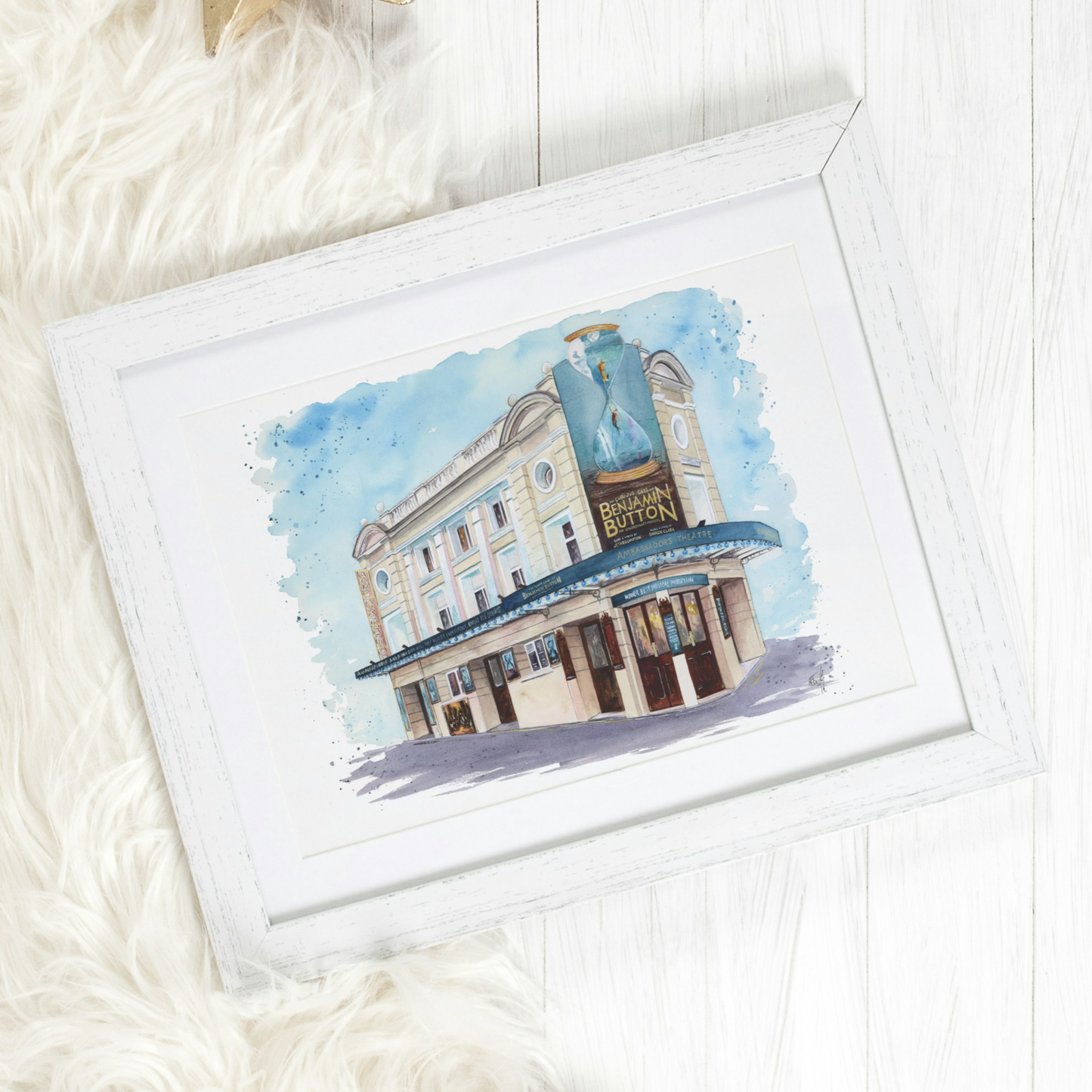 A watercolour painting of the Ambassadors Theatre in London's West End featuring the Marquee for 'the Curious Case of Benjamin Button'. Painted by Eve Leoni Art.