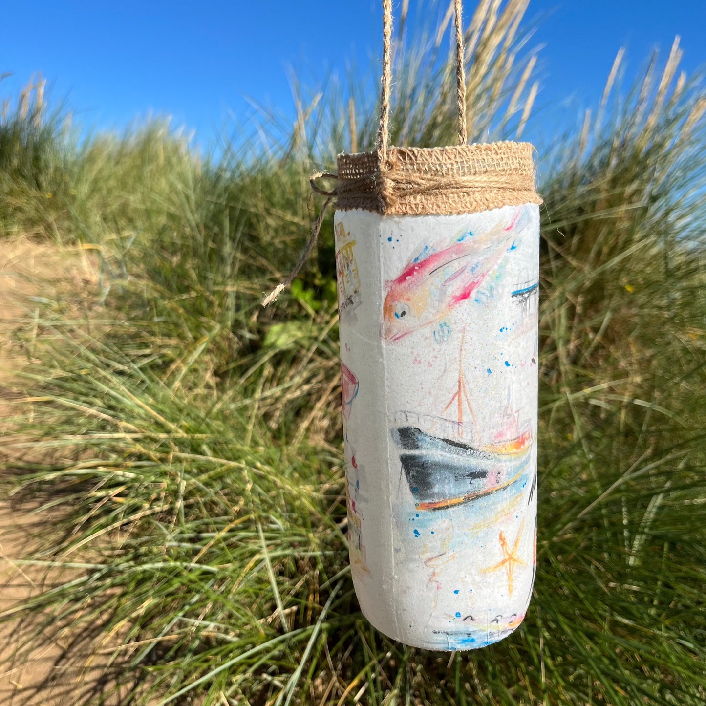 A decoupaged jar featuring watercolour illustrations of local landmarks in Grimsby and Cleethorpes by local artist, Eve Leoni Smith and Jollpotz.