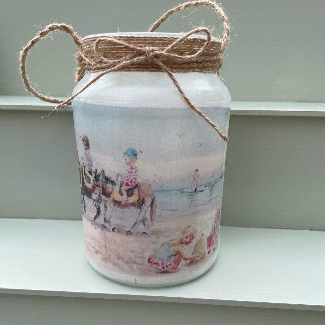 Decoupaged firefly jar featuring watercolour artwork of Cleethorpes beach by Eve Leoni Art.