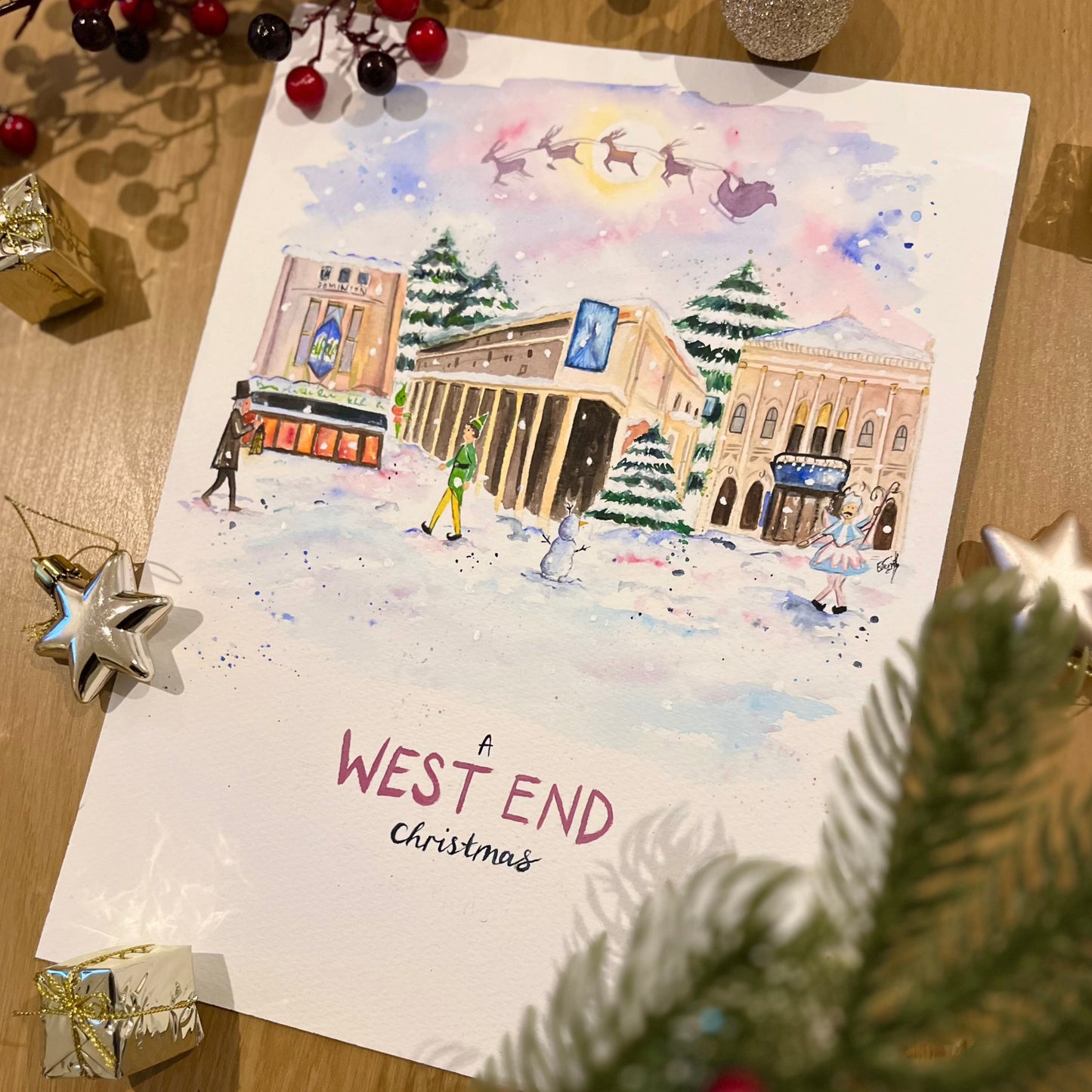 A watercolour illustration featuring the Dominion Theatre, the Theatre Royal Drury Lane, the London Palladium during winter in London's West End. Painted my local artist and performer, Eve Leoni Smith.