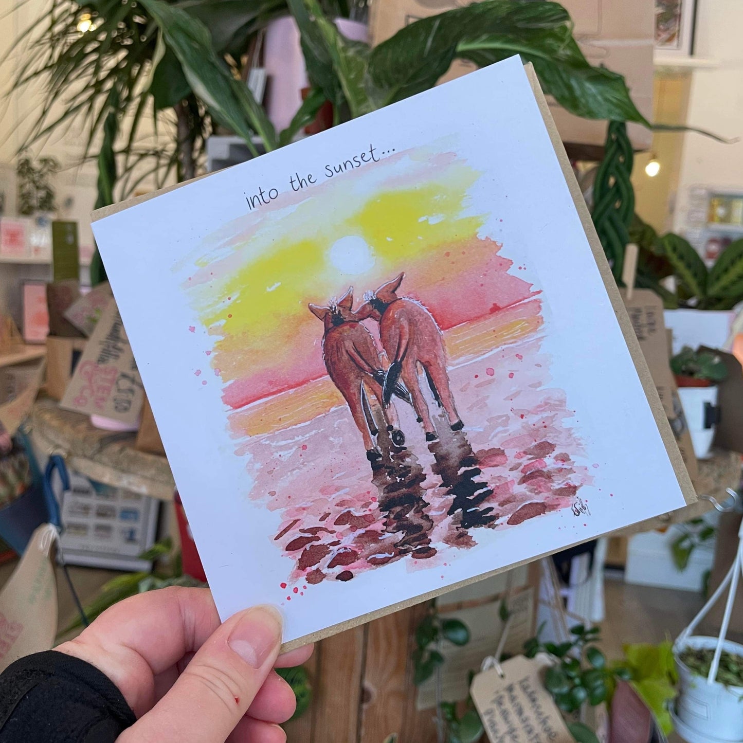 A recycled greetings card featuring two donkeys walking into the sunset on Cleethorpes beach, painted by Eve Leoni Smith, a local Grimsby artist.