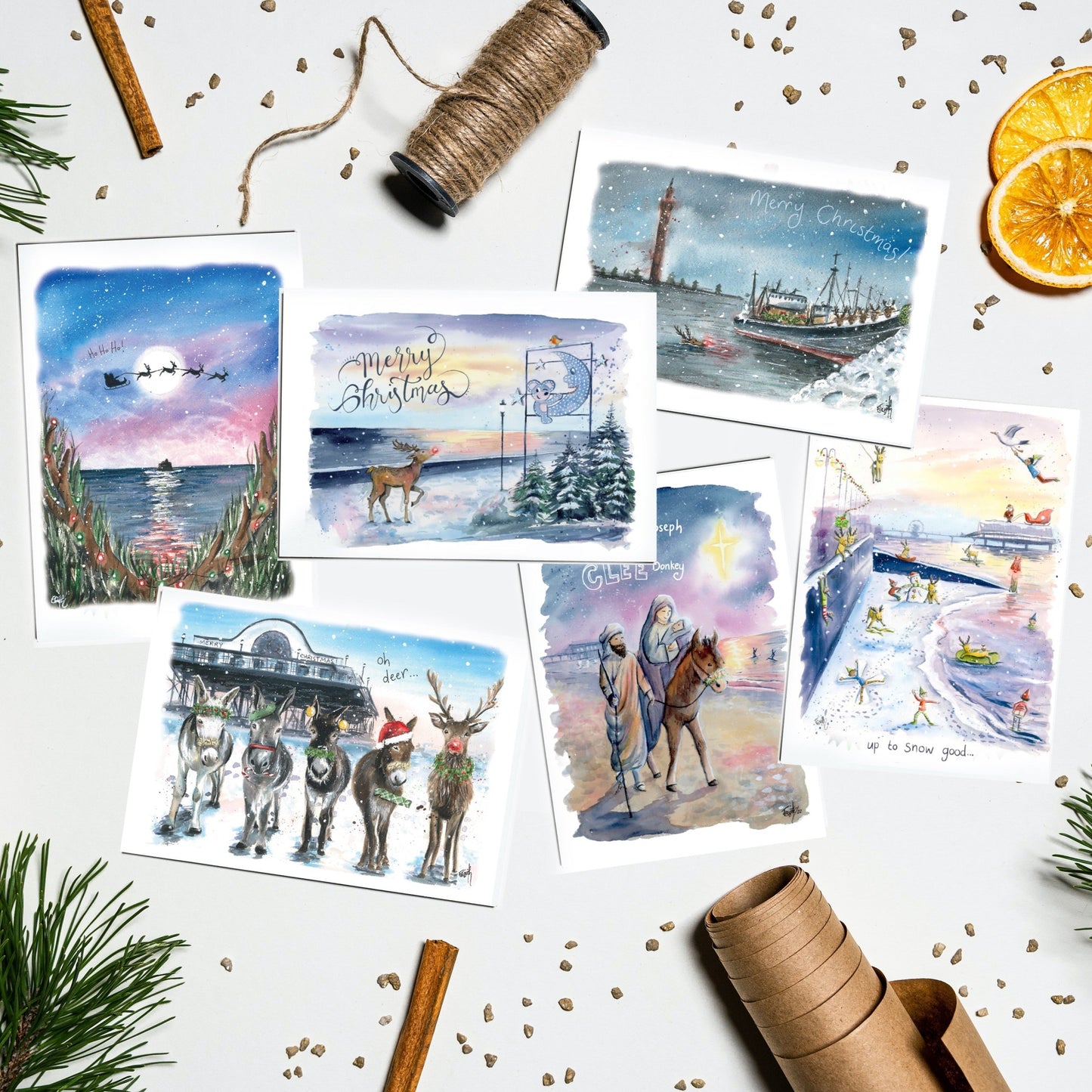 An assortment of Christmas cards featuring watercolour paintings of Grimsby and Cleethorpes by local artist and illustrator, Eve Leoni Smith. Paintings feature the Cleethorpes Pier, the Mouse and the Moon and the Grimsby Dock Tower.