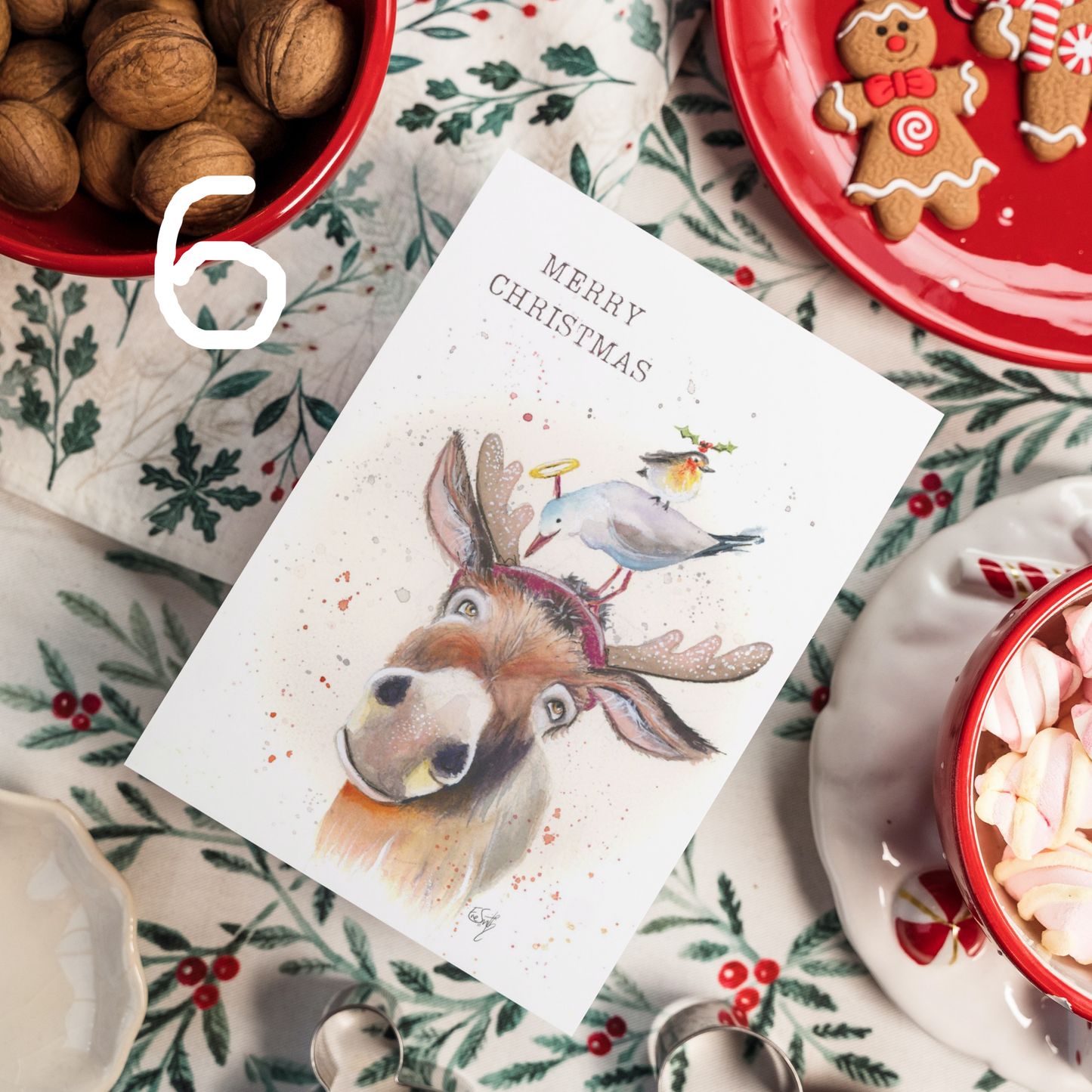 A watercolour illustration of a donkey, seagull and robin celebrating Christmas together in fancy dress. Painted by artist, Eve Leoni Smith.