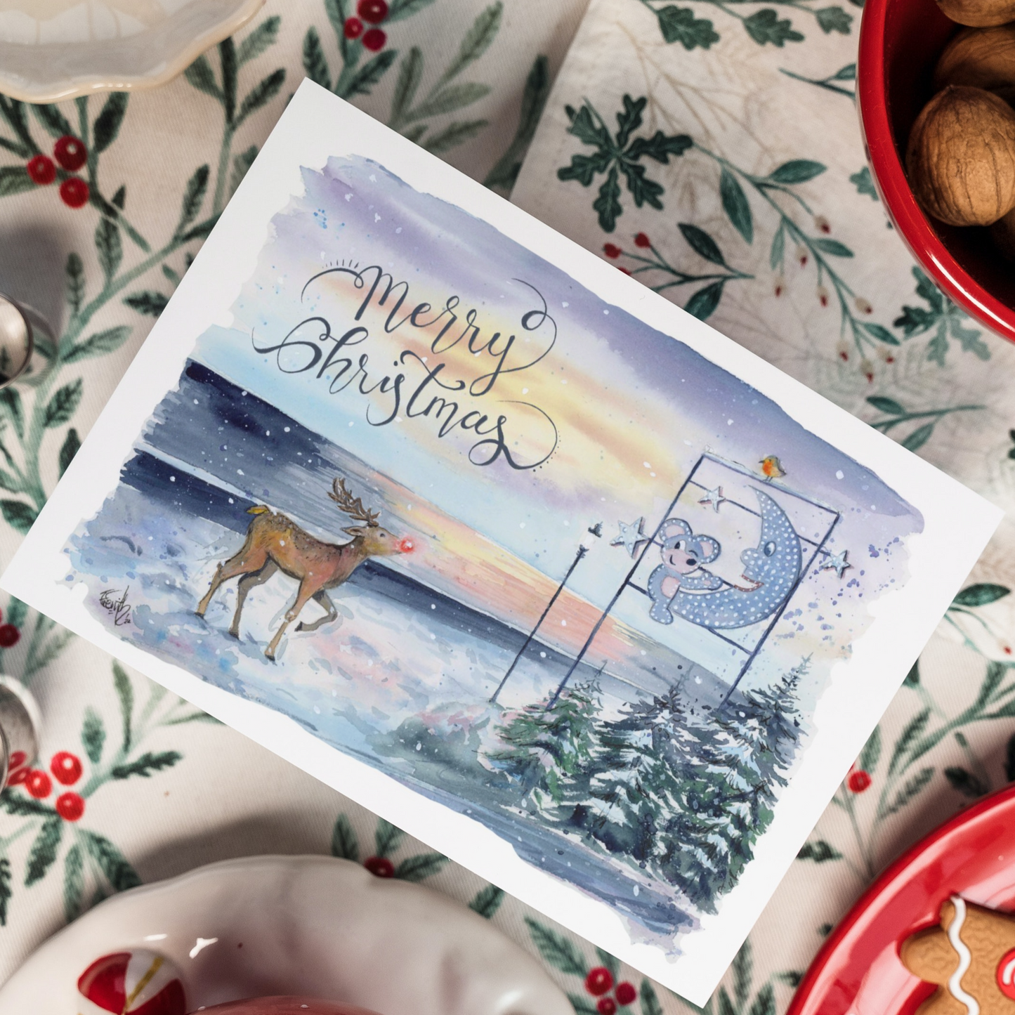 A local Christmas card featuring the Mouse and the Moon on Cleethorpes Seafront, and Rudolph the Reindeer looking up curiously. Painted in watercolours by popular Grimsby artist, Eve Leoni Smith.