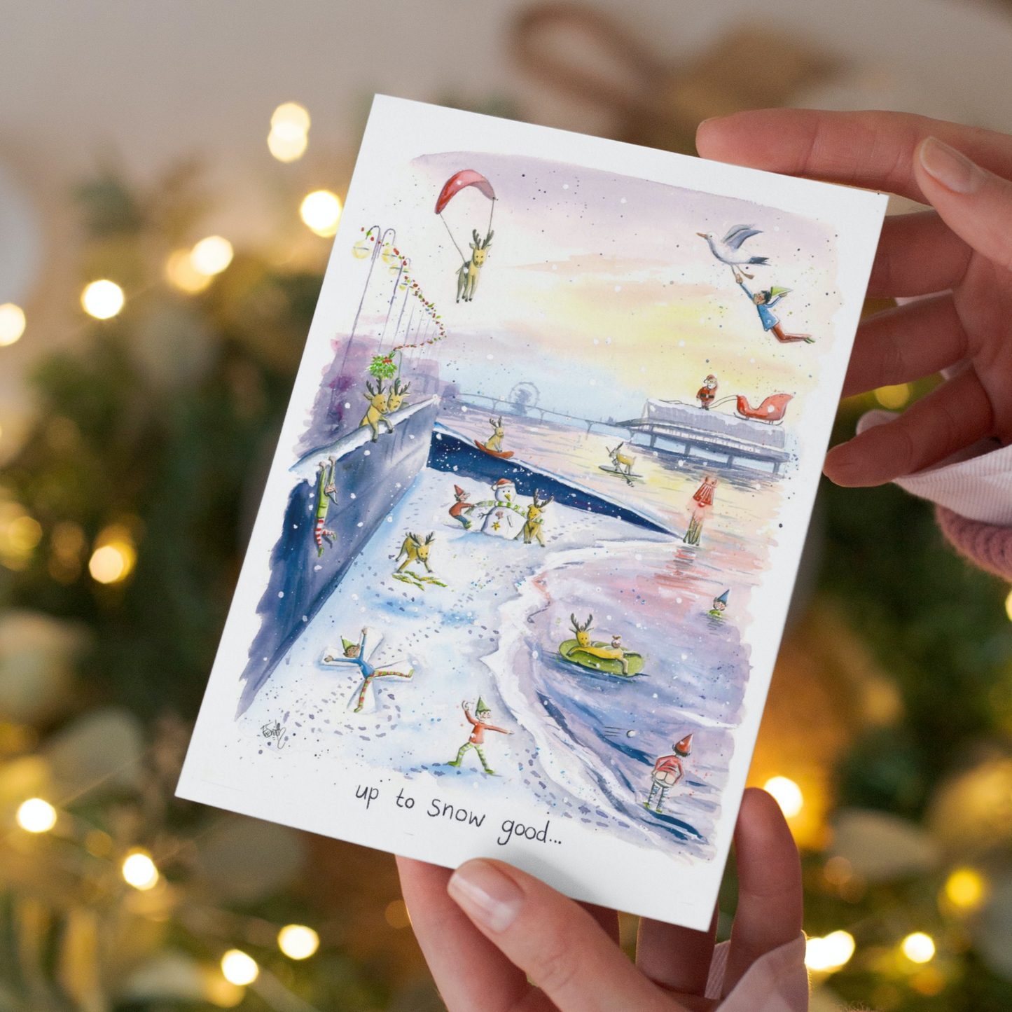 A comical watercolour illustration of a busy Christmas scene on Cleethorpes beach by local artist, Eve Leoni Smith.