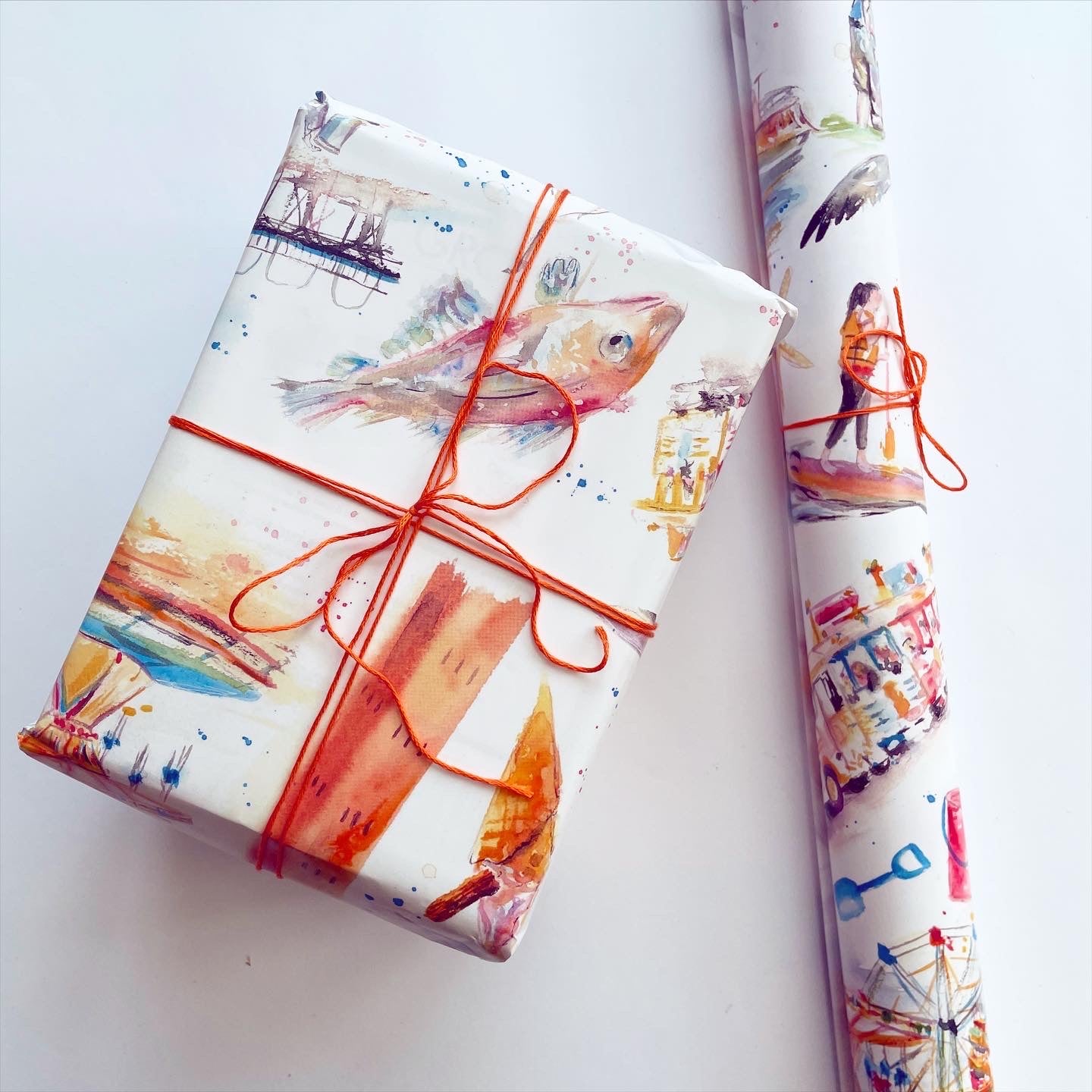 Luxury gift wrap featuring watercolour illustrations of local landmarks in Grimsby and Cleethorpes such as the Dock Tower and Cleethorpes Pier by Eve Leoni Smith.