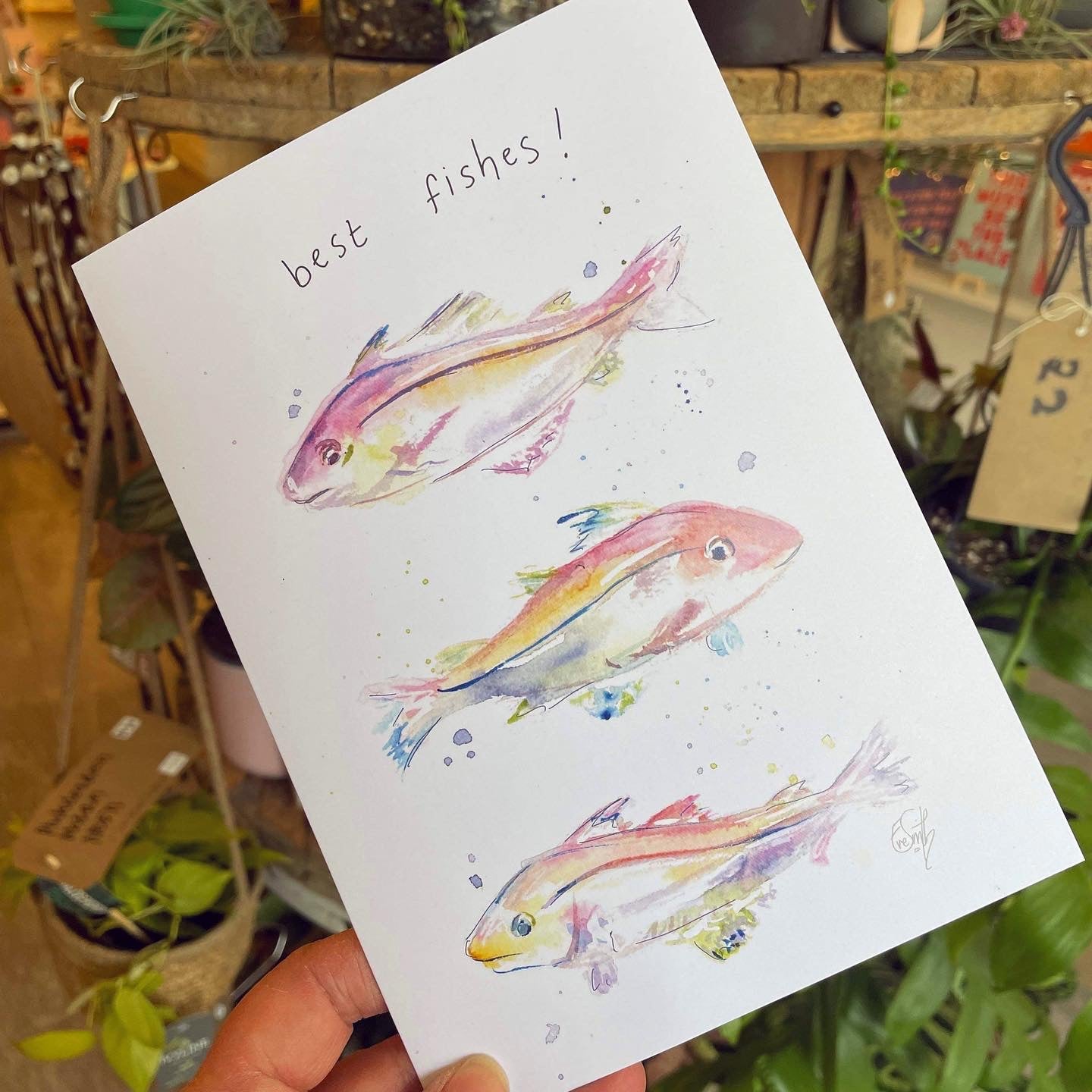 A greetings card featuring three Grimsby haddock watercolour illustrations with the caption, 'Best Fishes'. Designed and painted by Eve Leoni Smith. 