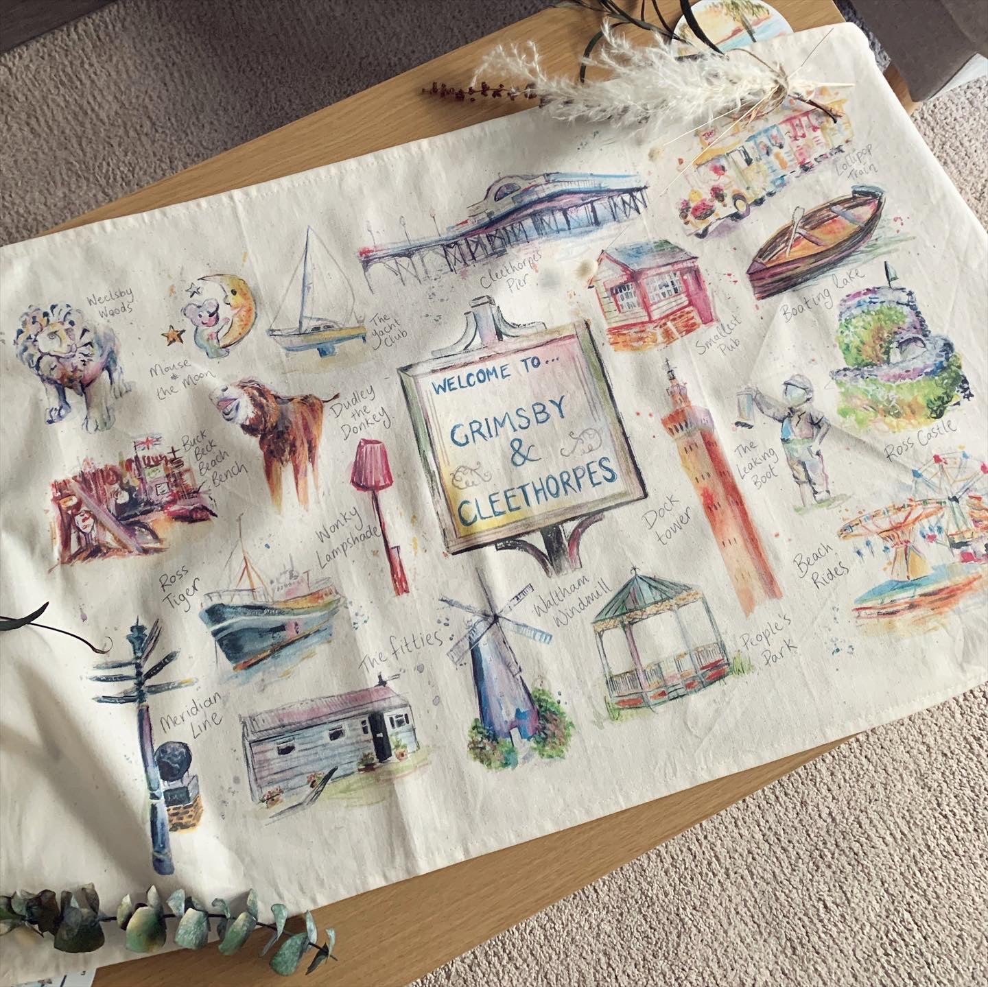 Luxury organic tea towel featuring illustrations of the local area in Grimsby and Cleethorpes, by Eve Leoni Art. 
