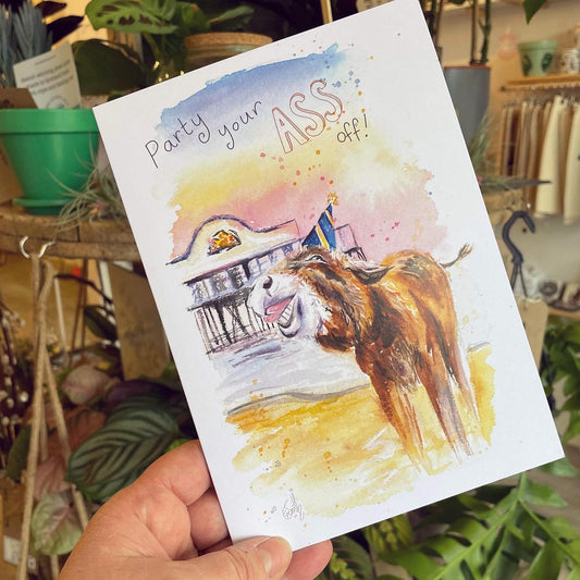 A popular greetings card featuring a donkey celebrating in front of Cleethorpes Pier, designed and painted by local artist, Eve Leoni Smith. 