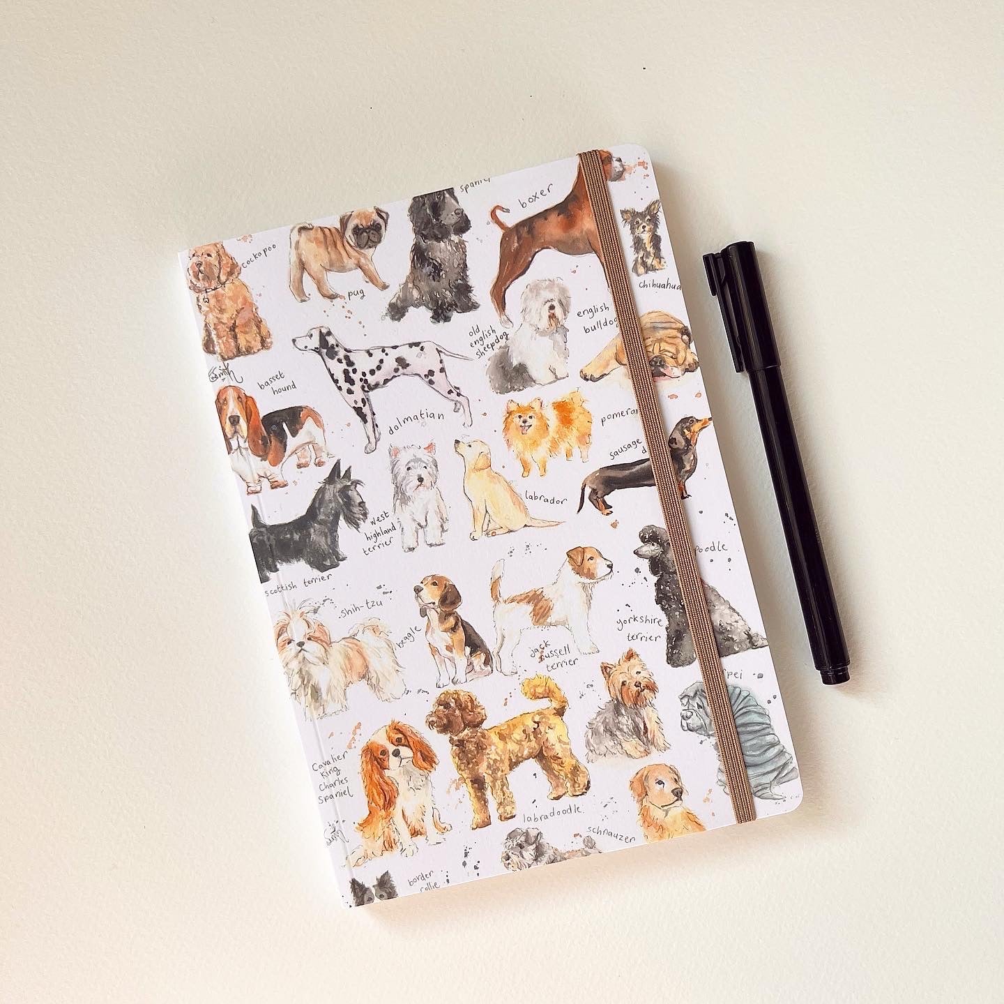 A perfect bound, luxury softcover notebook featuring illustrations of different dog breeds by Lincolnshire based artist, Eve Leoni Smith.