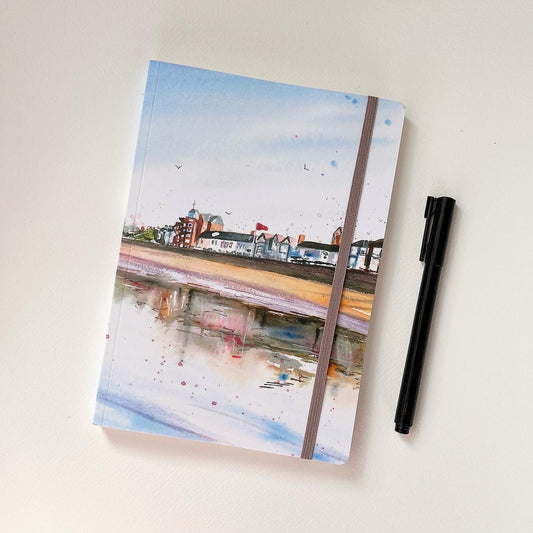A luxury softcover notebook featuring an original watercolour painting of the Cleethorpes seafront by Eve Leoni Smith, a local Grimsby artist.