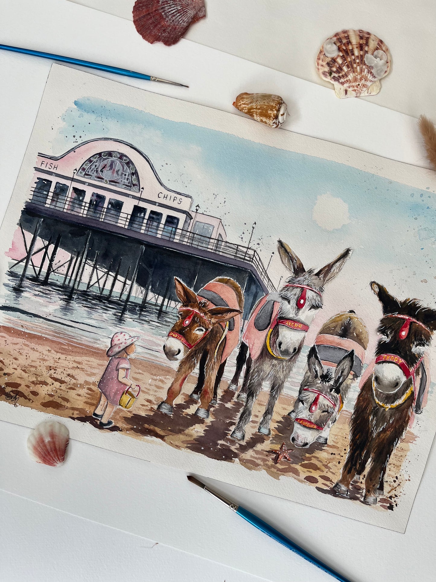 These charming donkeys on in front of Cleethorpes pier have been painted in watercolours by local Grimsby artist, Eve Leoni Smith.