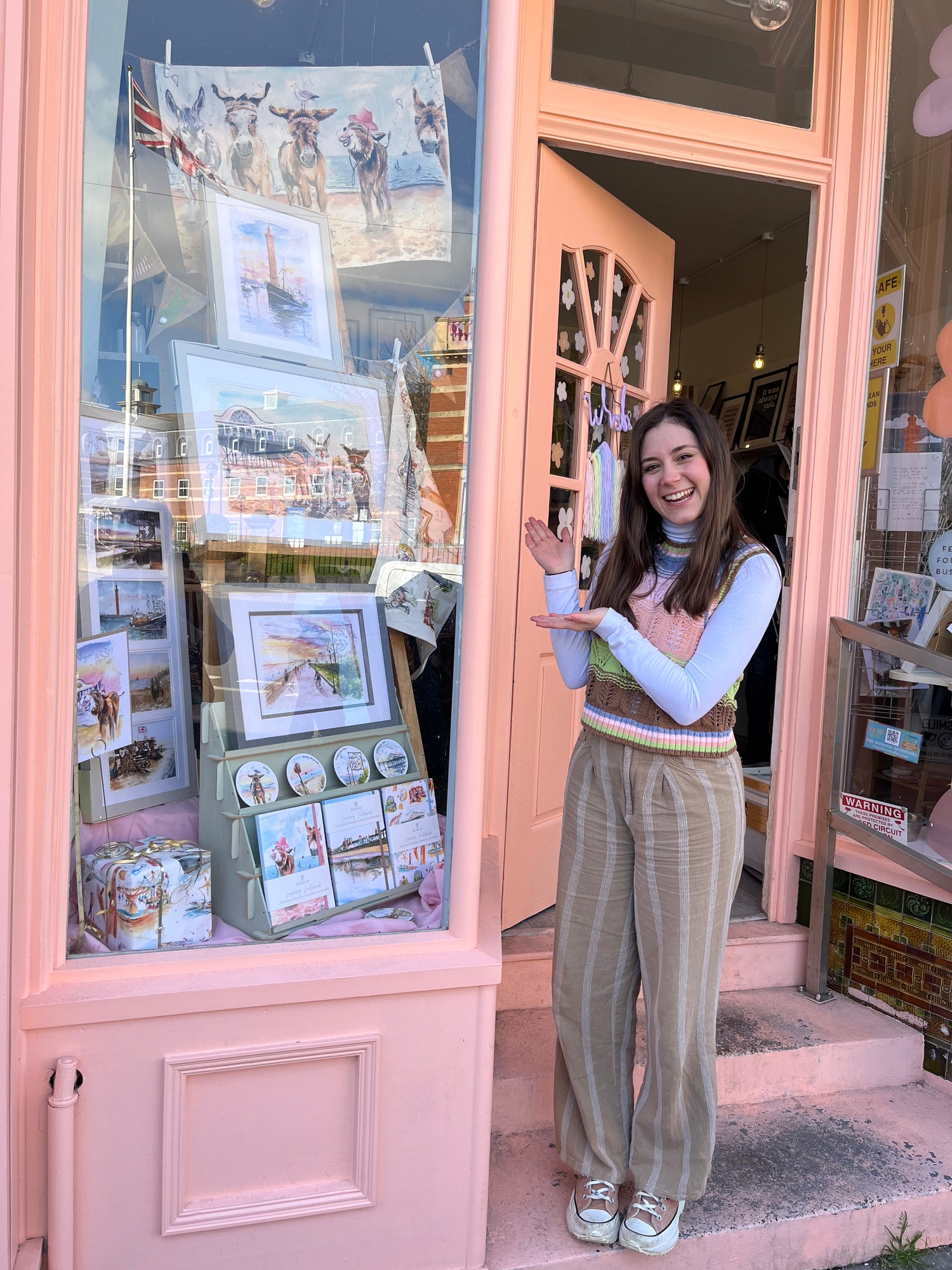 Local artist, Eve Leoni Smith, stood in front of the Original Emporium, Cleethorpes with her art window display.