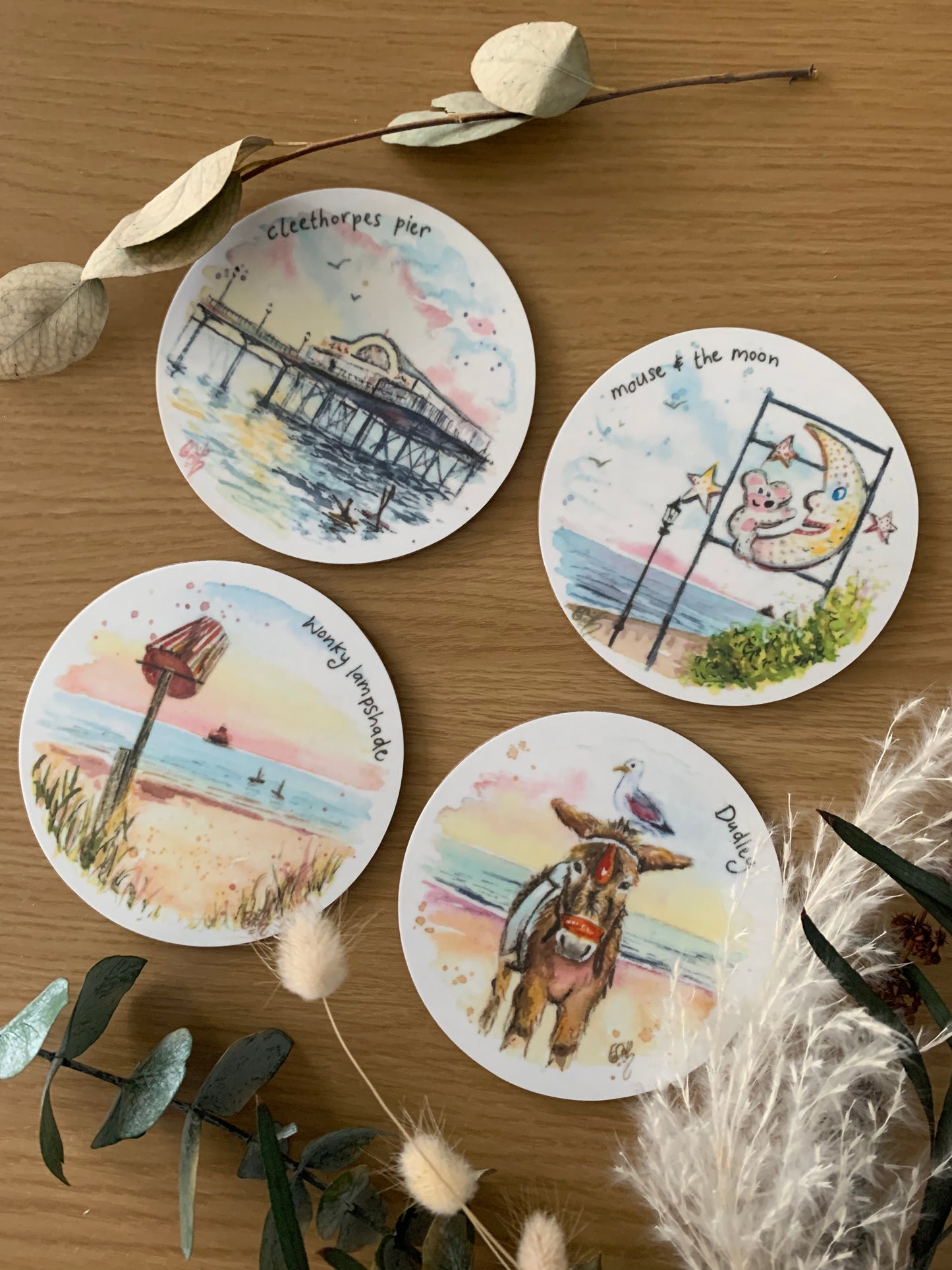 A set of four melamine coasters featuring watercolour illustrations of local landmarks in Cleethorpes by Eve Leoni Smith. 