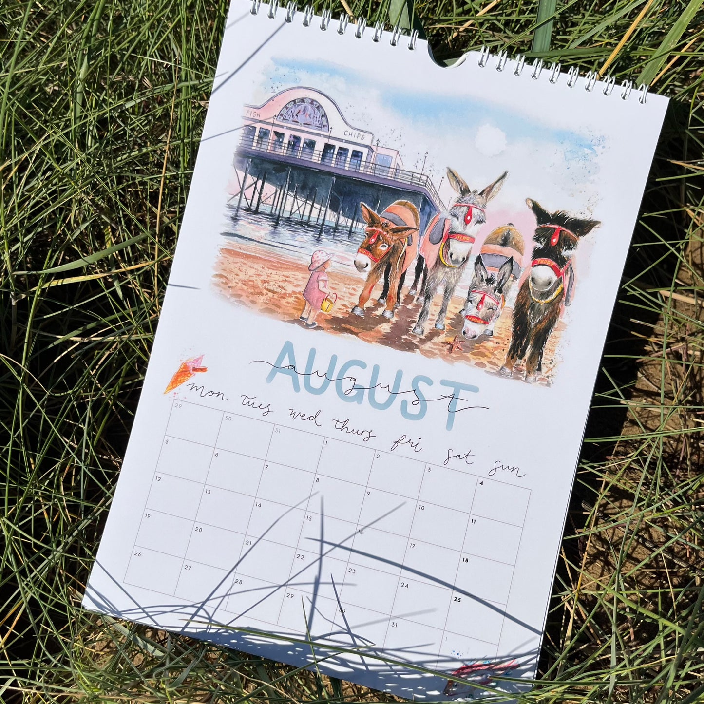 A Cleethorpes calendar for 2024 featuring the donkeys in front of Cleethorpes pier, by local artist, Eve Leoni Smith. 