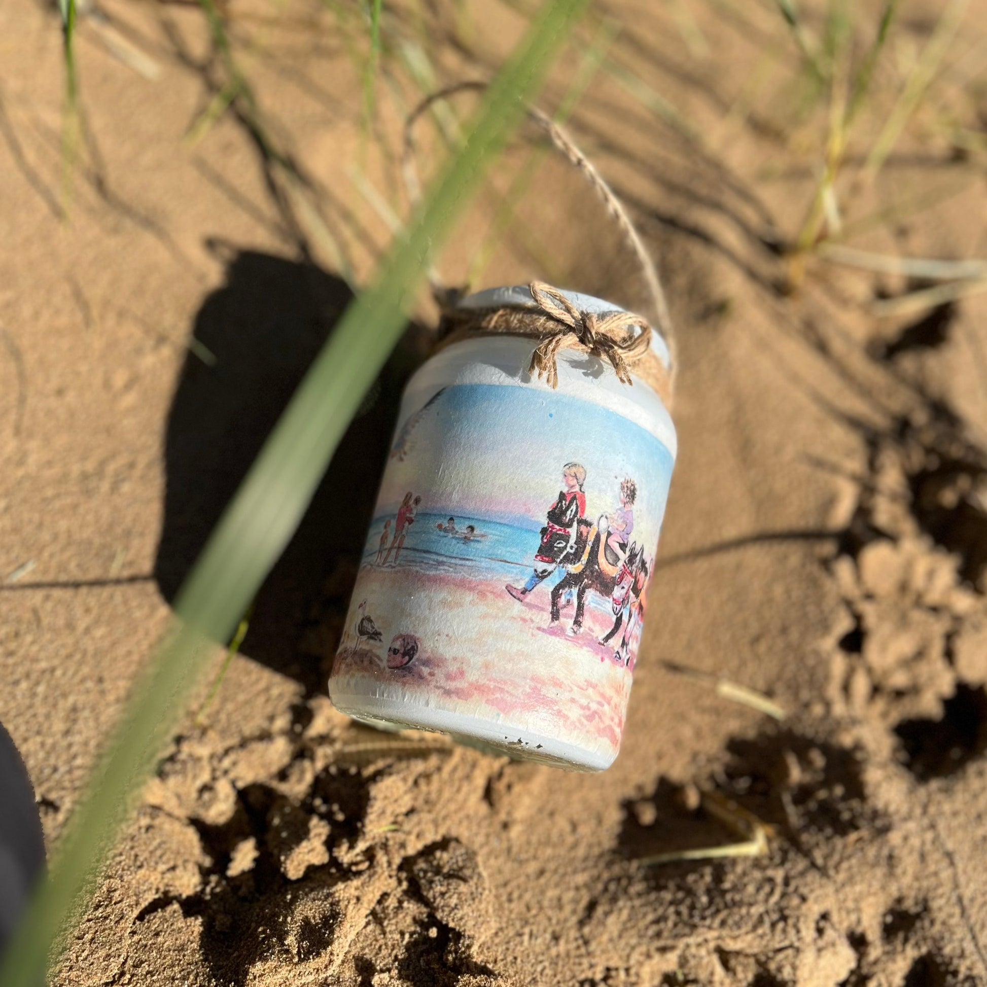 A decorative jar featuring watercolour artwork by Eve Leoni Smith on Cleethorpes Beach. 