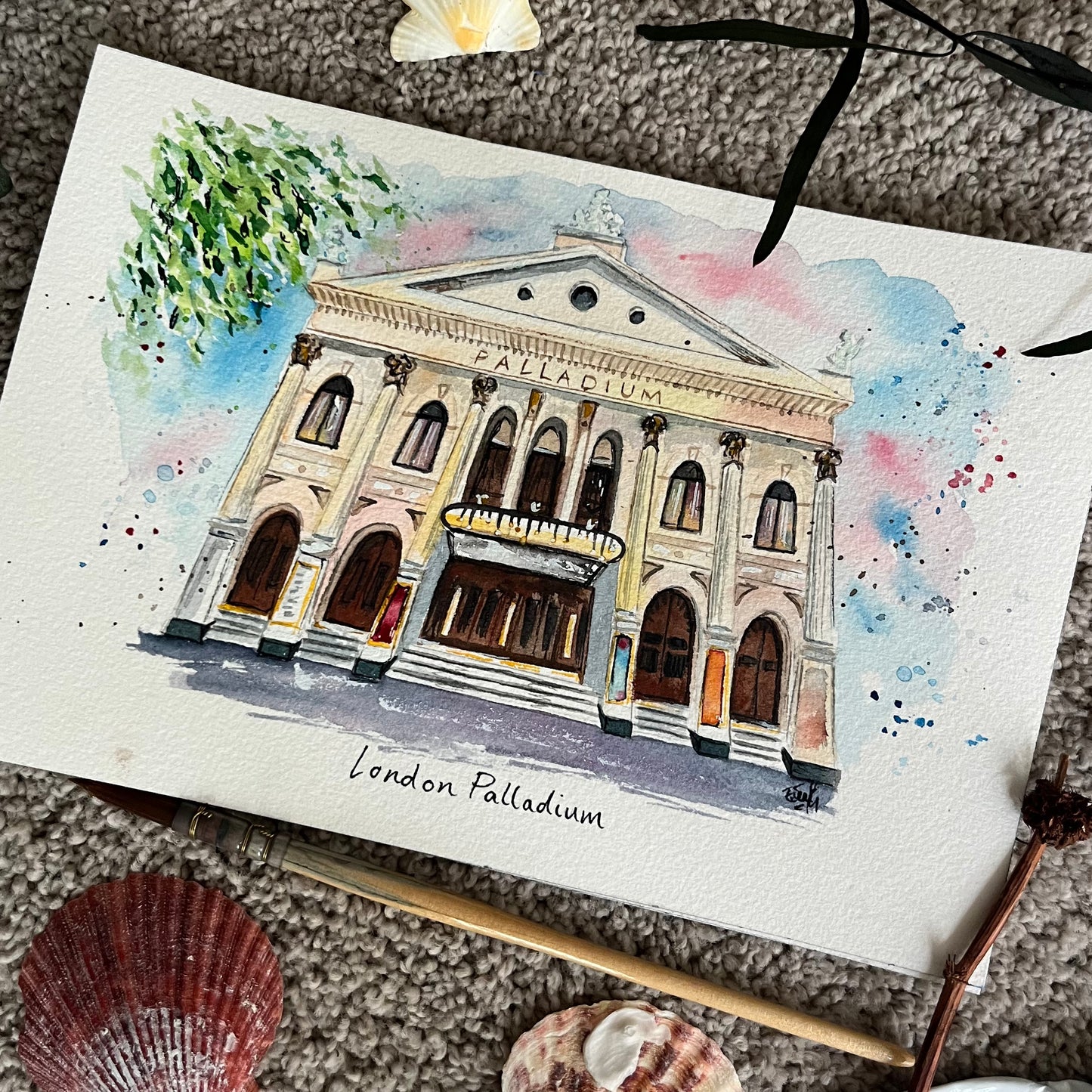 This watercolour painting features an illustration of the London Palladium in London's West End. Painted by local artist and performer, Eve Leoni Smith.