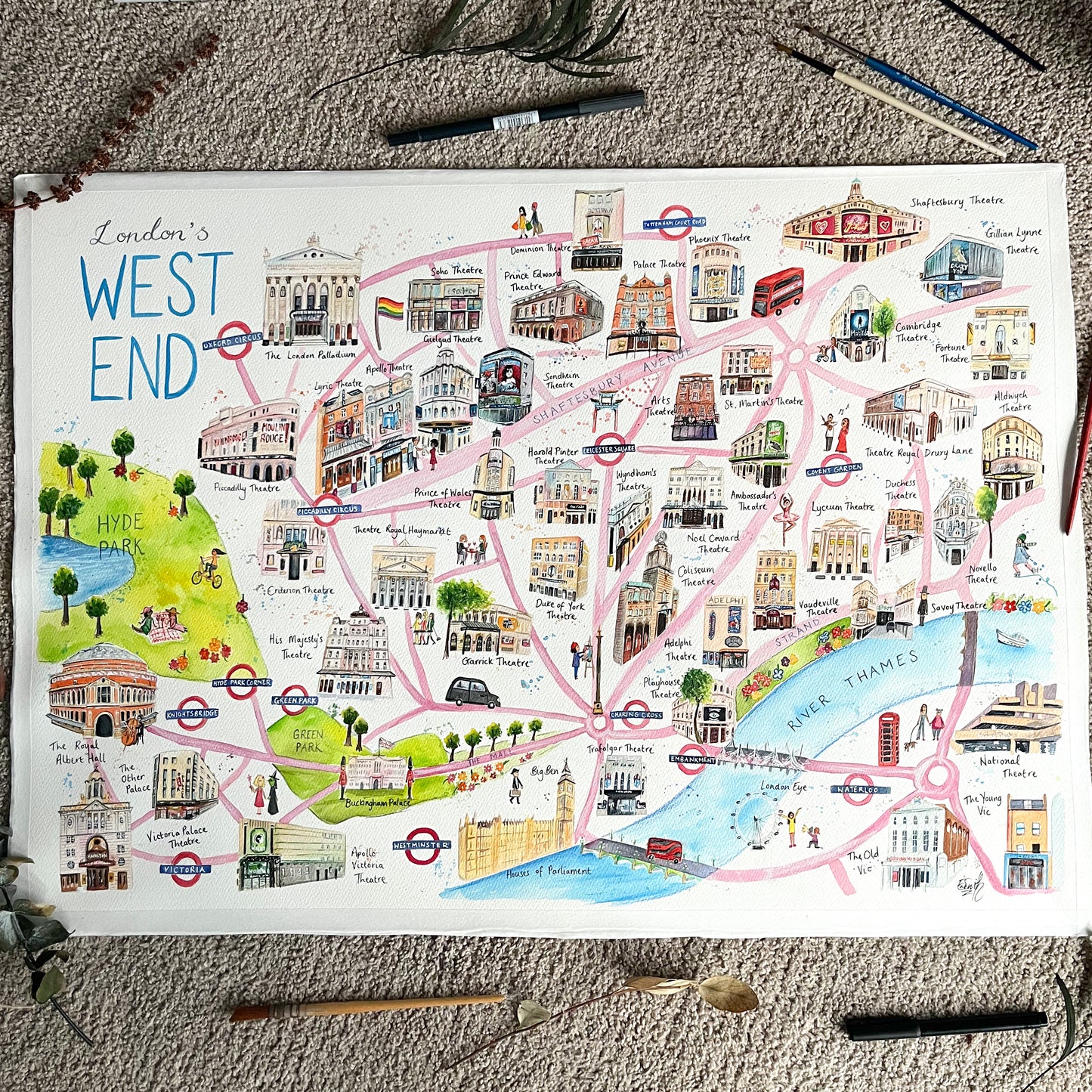 A large watercolour map of the West End by London artist, Eve Leoni Art, featuring west end theatre illustrations of the London Palladium, Royal Albert Hall, National Theatre, His Majesty's Theatre and more.