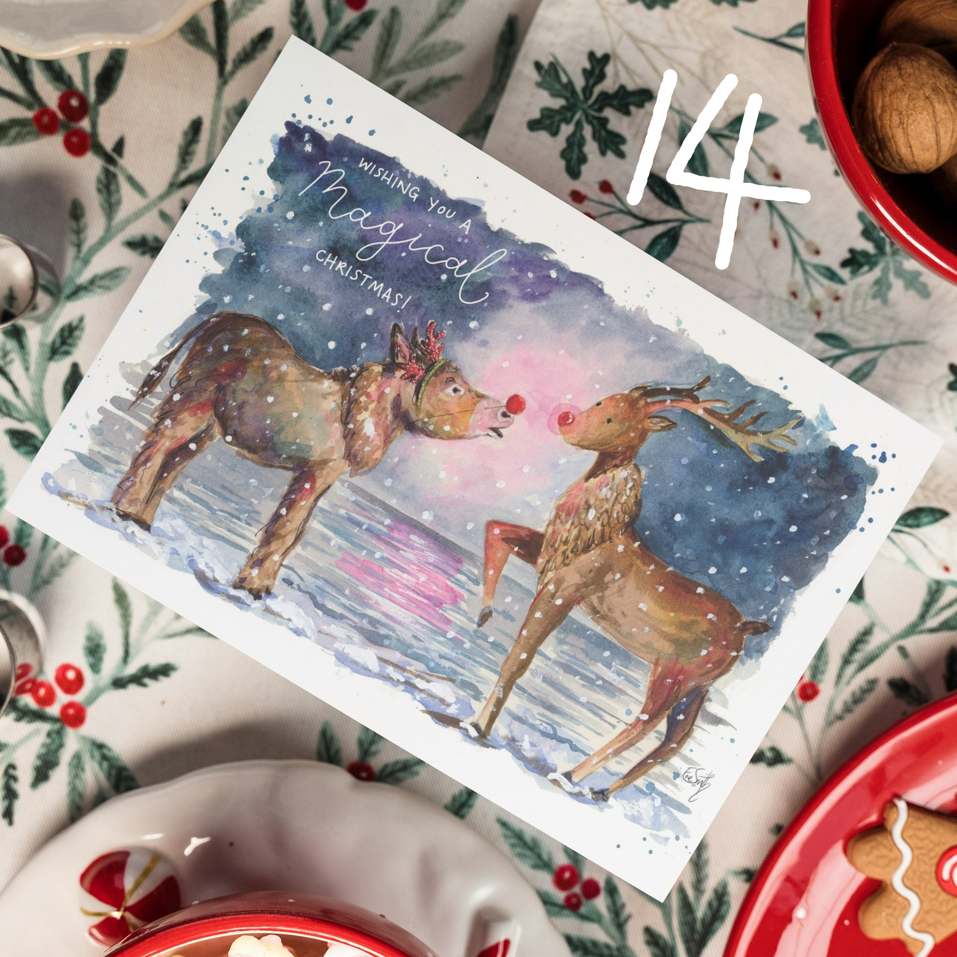 A watercolour christmas card featuring a design of a donkey on Cleethorpes Beach meeting Rudolph for the first time. Text reads 'Wishing you a Magical Christmas.' Painted by Cleethorpes artist, Eve Leoni Smith.